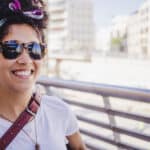 brunette-smiling-girl-sunglasses-standing-outside