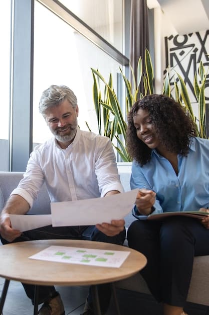 A professional advisor meeting with a client in a modern office, reviewing documents related to Opportunity Zone investments and discussing financial strategies for community development.