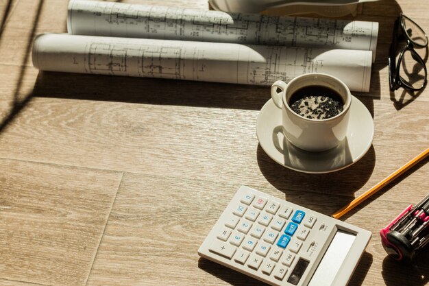 A close-up shot of a calculator displaying calculations related to retirement distributions, sitting on top of a financial newspaper with articles about retirement planning.