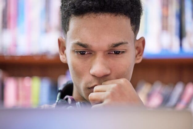 A student taking the digital SAT on a laptop in a quiet testing environment, focused on the screen with a determined expression.